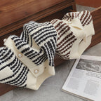 Knitted cardigans with striped pattern on a dark surface