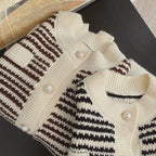 Knitted cardigans with striped pattern on a dark surface
