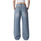 Blue jeans worn by a person on a white background
