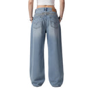 Blue jeans worn by a person on a white background