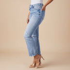 Angled view of women's washed distressed ripped denim jeans